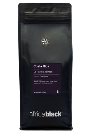 Black coffee bag with 'africa black' branding and Costa Rica La Pastora Tarrazu label on a white background