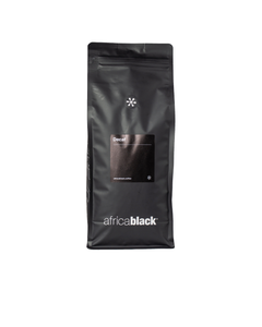 Black matte resealable bag of colombian decaf coffee with minimalist white branding featuring sugar cane process