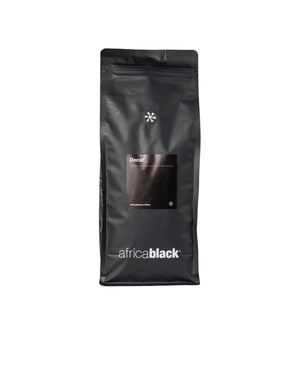 Black matte resealable bag of colombian decaf coffee with minimalist white branding featuring sugar cane process