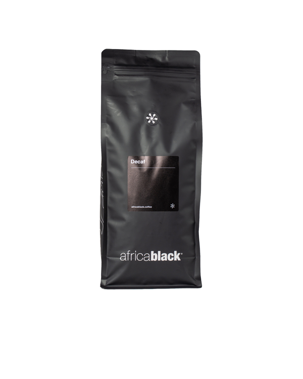 Black matte resealable bag of colombian decaf coffee with minimalist white branding featuring sugar cane process